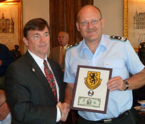JACKSONVILLE—Capt. Dan Bean, USN, (Ret.), president of the Adams Class Museum effort in Jacksonville, presents a plaque to Lt. Col. Volker Kozok of the German Military Cyber Delegation visiting Jacksonville in June.